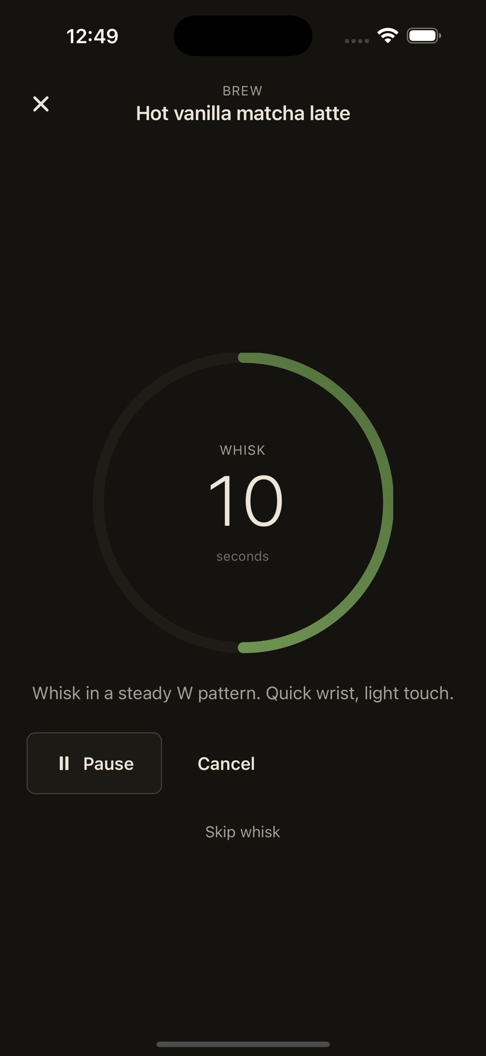 Guided brew timer for the hot vanilla matcha latte, with a green progress ring counting down 10 seconds of whisking, the instruction to whisk in a steady W pattern, and pause, cancel and skip whisk controls.