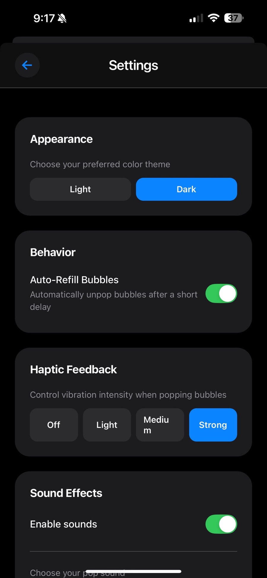 Popwell's Settings screen with a Light and Dark appearance switch set to Dark, an Auto-Refill Bubbles toggle turned on, haptic feedback intensity set to Strong out of Off, Light, Medium and Strong, and sound effects enabled.